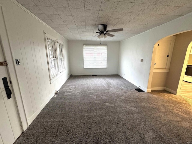 2747 Washington Ave, Bedford, IN 47421 - spare room featuring arched walkways, ceiling fan, ornamental molding, and carpet
