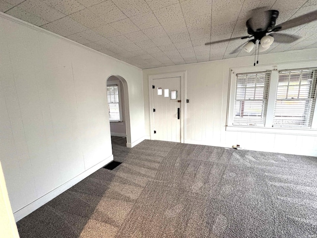 2747 Washington Ave, Bedford, IN 47421 - carpeted spare room with arched walkways, ceiling fan, and a healthy amount of sunlight