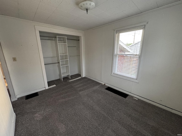 2747 Washington Ave, Bedford, IN 47421 - unfurnished bedroom featuring a closet, visible vents, and dark colored carpet