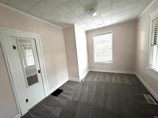 2747 Washington Ave, Bedford, IN 47421 - empty room with plenty of natural light, visible vents, ornamental molding, and dark colored carpet