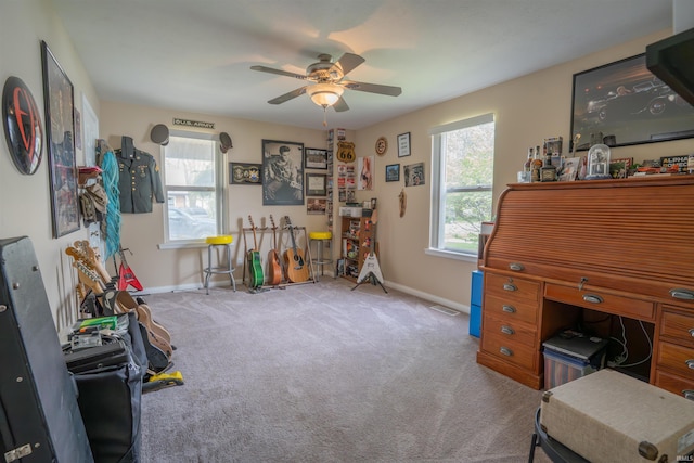 carpeted office featuring a ceiling fan, baseboards, and visible vents