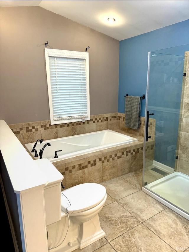 full bathroom featuring a stall shower, toilet, a bath, and tile patterned flooring