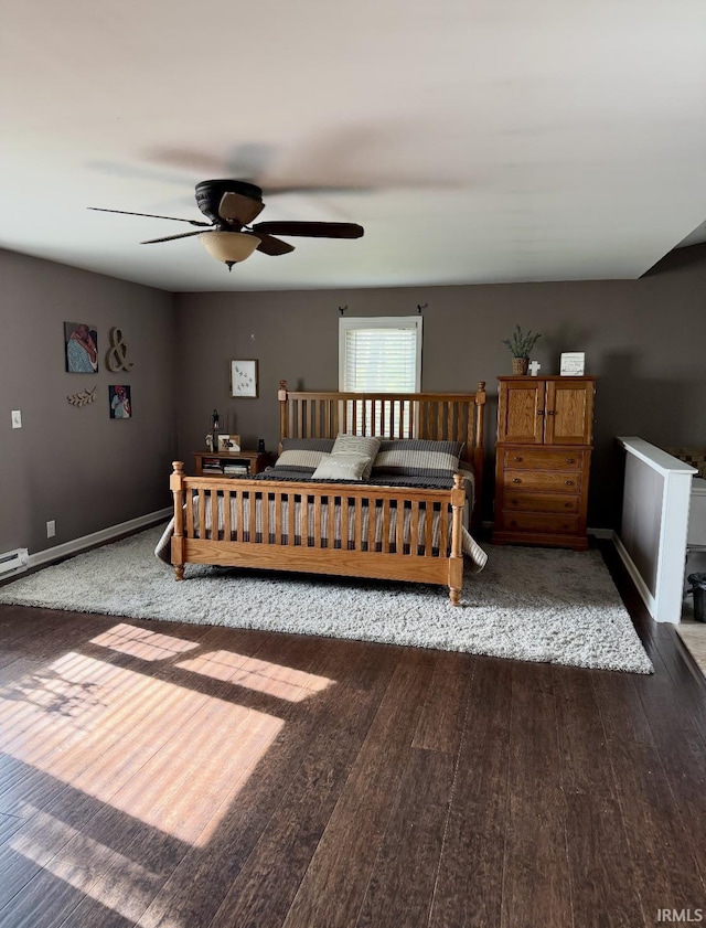 bedroom with baseboards and wood finished floors
