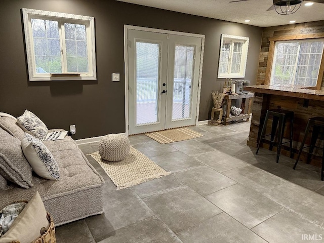 entryway with french doors and baseboards