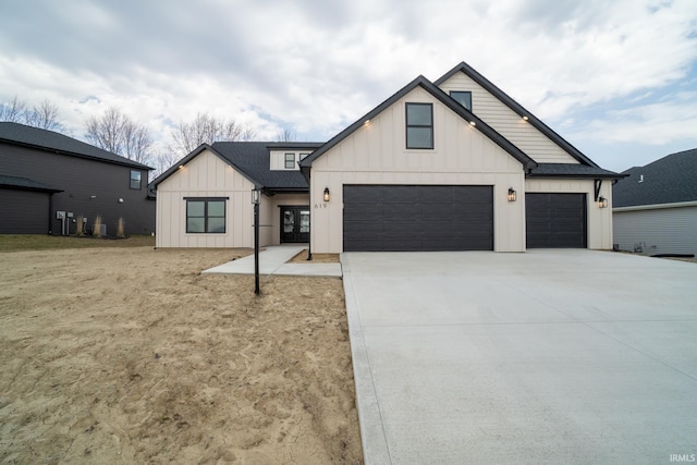 modern farmhouse with concrete driveway, a garage, and board and batten siding