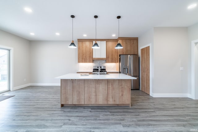 619 Sandringham Pass, Fort Wayne, IN 46845 - kitchen featuring appliances with stainless steel finishes, light countertops, light wood finished floors, and baseboards