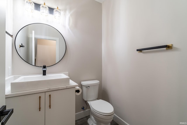 619 Sandringham Pass, Fort Wayne, IN 46845 - bathroom featuring baseboards, wood finished floors, toilet, and vanity