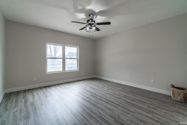 619 Sandringham Pass, Fort Wayne, IN 46845 - empty room with visible vents, ceiling fan, wood finished floors, and baseboards