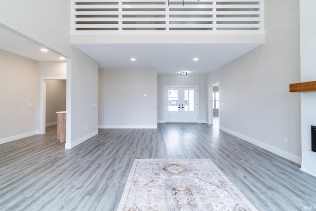 619 Sandringham Pass, Fort Wayne, IN 46845 - unfurnished living room featuring a glass covered fireplace, wood finished floors, and baseboards