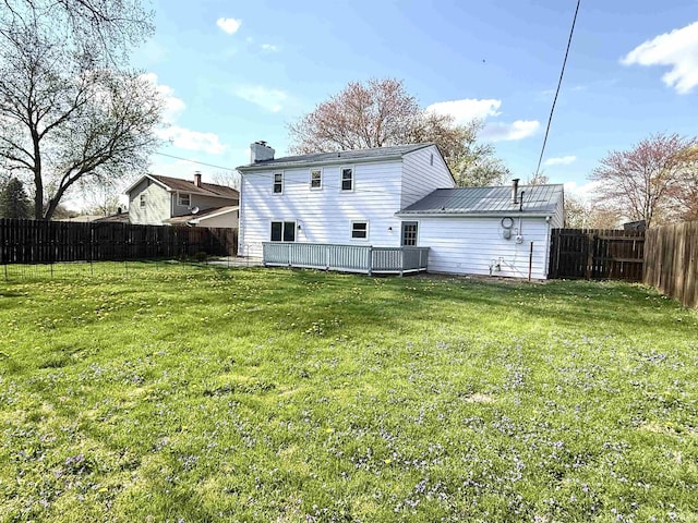 5126 Martinique Rd, Fort Wayne, IN 46815 - rear view of property featuring a wooden deck, metal roof, a fenced backyard, a lawn, and a chimney