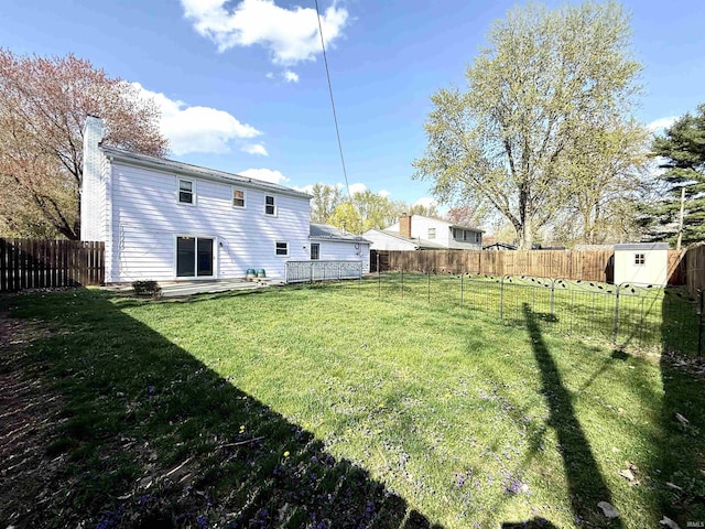 5126 Martinique Rd, Fort Wayne, IN 46815 - view of yard featuring an outdoor structure, a fenced backyard, and a storage shed