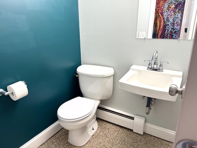 5126 Martinique Rd, Fort Wayne, IN 46815 - half bathroom featuring a sink, baseboard heating, baseboards, toilet, and speckled floor