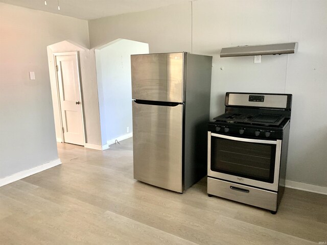 kitchen with baseboards, stainless steel appliances, and light wood finished floors