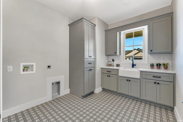 1152 Cascata Trl, Huntertown, IN 46748 - clothes washing area with hookup for an electric dryer, a sink, baseboards, and light floors