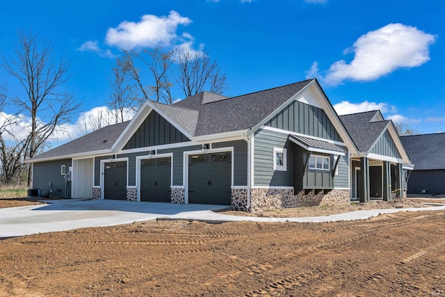 1152 Cascata Trl, Huntertown, IN 46748 - view of front of house with board and batten siding, a shingled roof, driveway, and an attached garage
