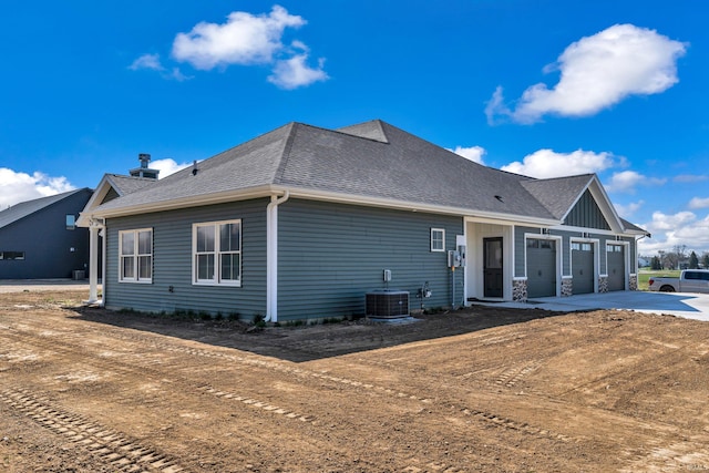 1152 Cascata Trl, Huntertown, IN 46748 - exterior space with driveway, a shingled roof, and central AC