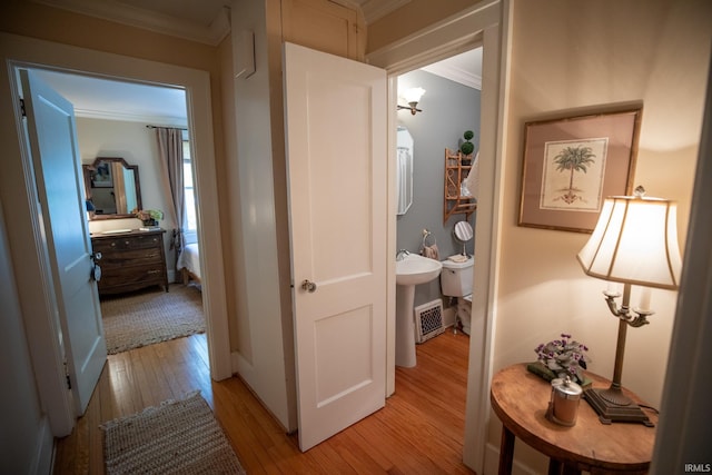 826 College Ave, Culver, IN 46511 - hallway with light wood-style floors and ornamental molding