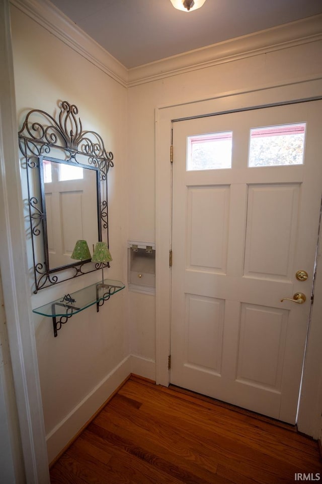 826 College Ave, Culver, IN 46511 - doorway to outside featuring wood finished floors, crown molding, and baseboards