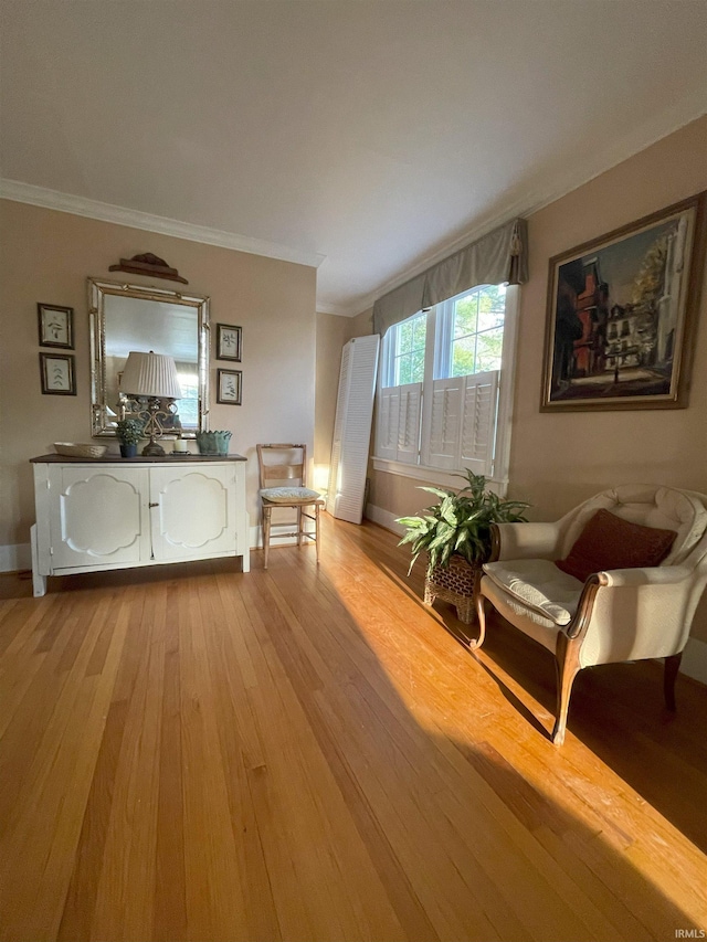 826 College Ave, Culver, IN 46511 - living area featuring crown molding, light wood-type flooring, and baseboards