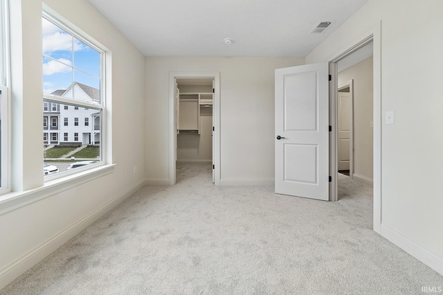 138 Parkerwood Ln, West Lafayette, IN 47906 - unfurnished bedroom with a walk in closet, visible vents, carpet floors, and baseboards