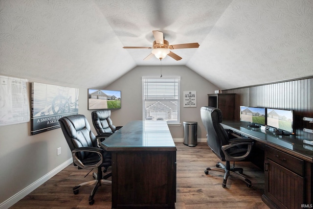 office area with wood finished floors, ceiling fan, vaulted ceiling, and a textured ceiling