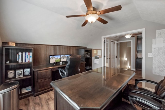 office area featuring lofted ceiling, wood finished floors, and a ceiling fan