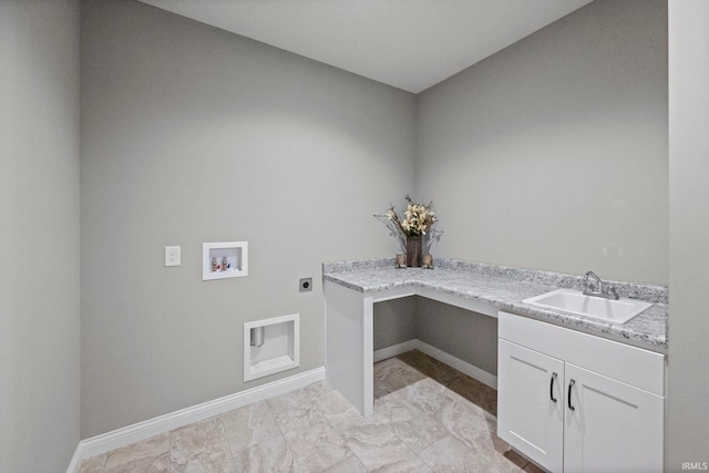 laundry room featuring hookup for an electric dryer, a sink, cabinet space, and baseboards