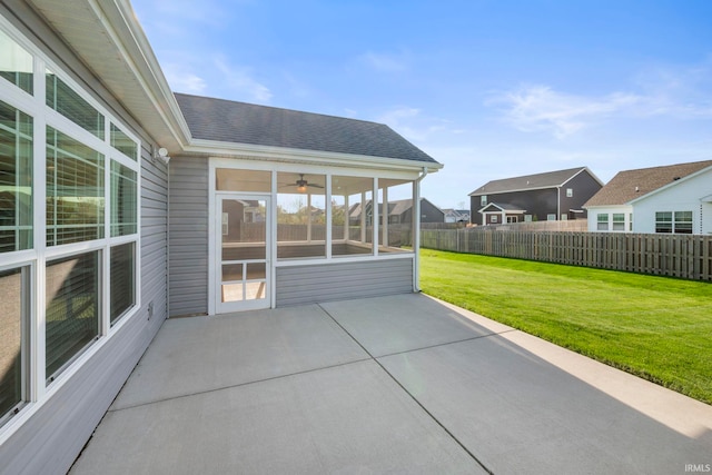 view of patio / terrace featuring fence and a sunroom