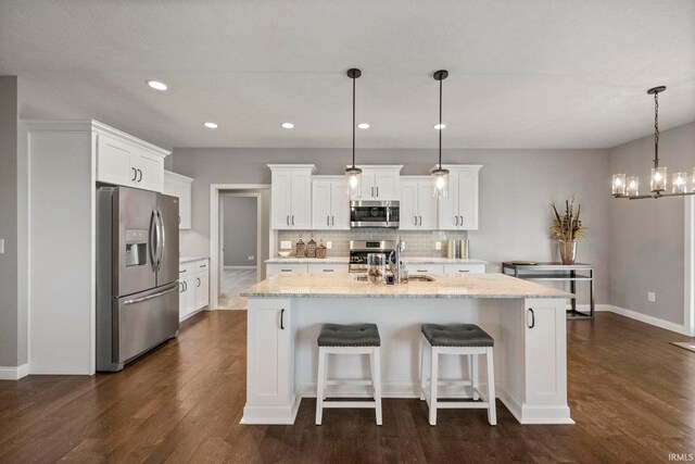 kitchen featuring recessed lighting, appliances with stainless steel finishes, backsplash, white cabinetry, and dark wood-type flooring