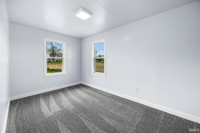 601 W Sherman St, Windfall, IN 46076 - spare room with dark colored carpet and baseboards