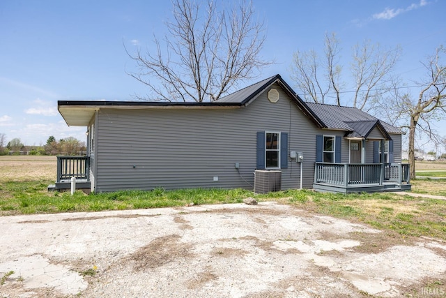 601 W Sherman St, Windfall, IN 46076 - rear view of property with central AC, a wooden deck, and metal roof