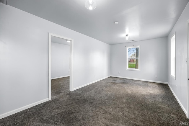 601 W Sherman St, Windfall, IN 46076 - empty room featuring dark colored carpet and baseboards