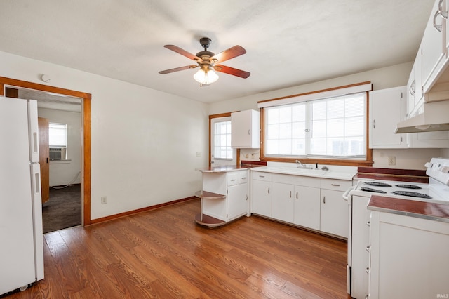 kitchen featuring light wood-type flooring, white appliances, a ceiling fan, and plenty of natural light