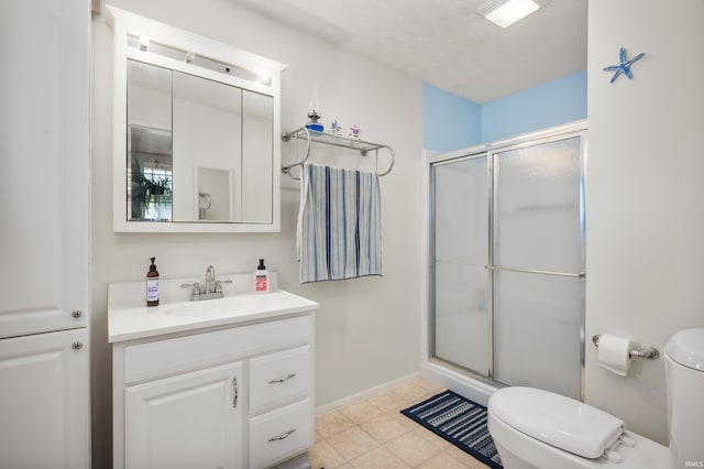 bathroom featuring toilet, a shower stall, vanity, and baseboards