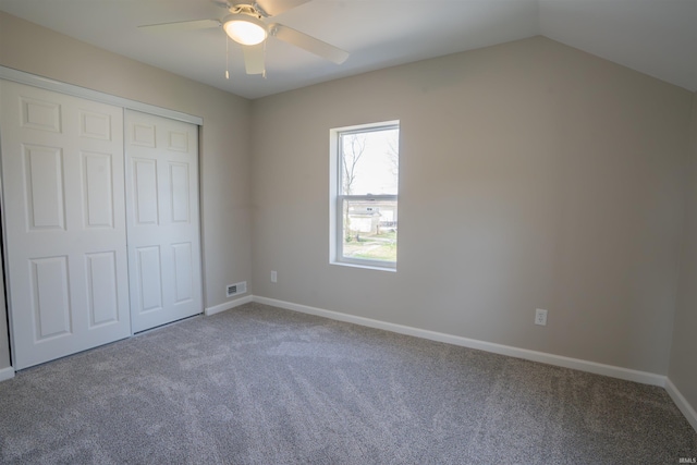 unfurnished bedroom featuring baseboards, visible vents, carpet floors, and a closet