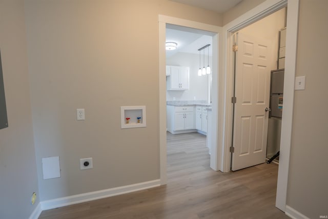 hall featuring baseboards and wood finished floors