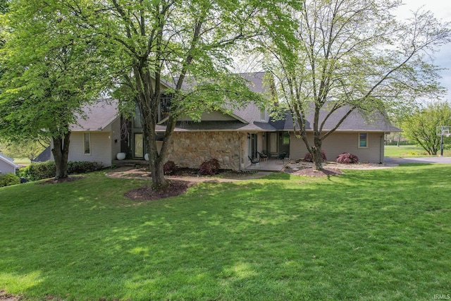 view of front of house featuring a front lawn and stone siding