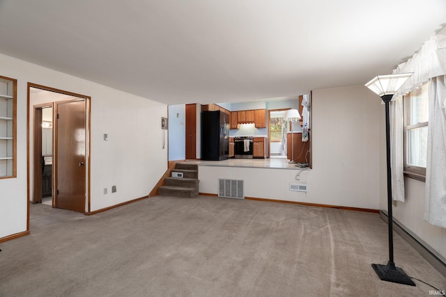 unfurnished living room featuring light colored carpet, visible vents, stairs, and baseboards