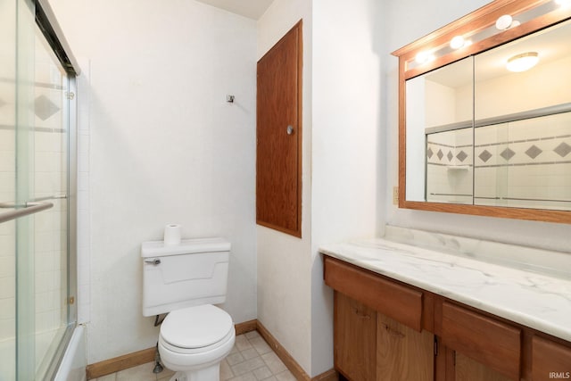 full bath featuring baseboards, toilet, enclosed tub / shower combo, and vanity