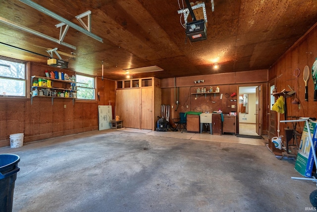 garage featuring wooden walls and a garage door opener