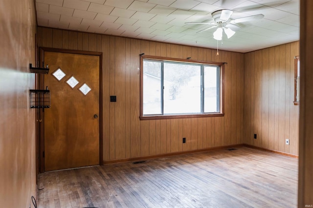 208 Mable St, Paoli, IN 47454 - entryway featuring ceiling fan, visible vents, wood walls, baseboards, and hardwood / wood-style floors