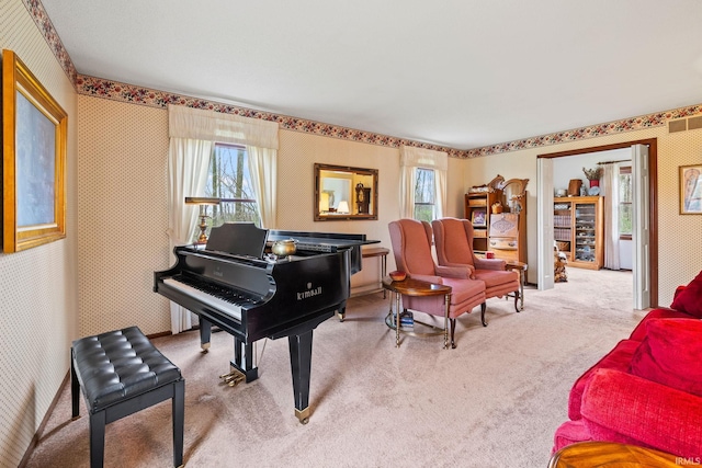 living area featuring carpet and wallpapered walls