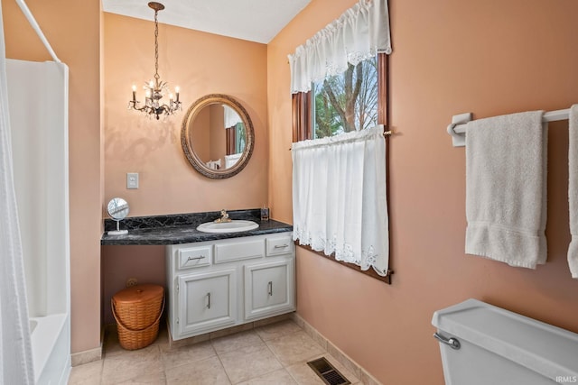 bathroom with visible vents, baseboards, vanity, a notable chandelier, and tile patterned flooring