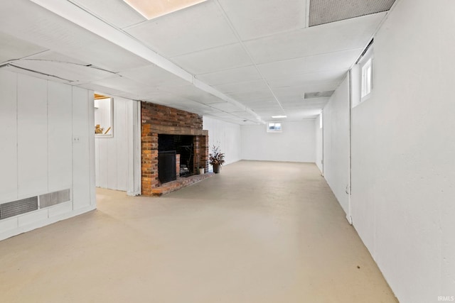 below grade area with visible vents and a brick fireplace