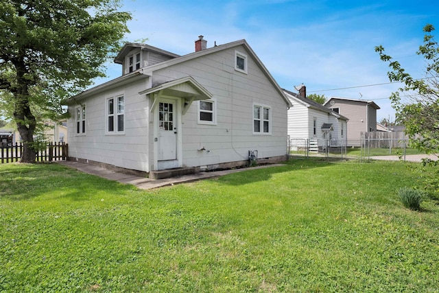 314 S Welworth Ave, Evansville, IN 47714 - back of house with fence, a chimney, and a lawn