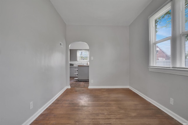 314 S Welworth Ave, Evansville, IN 47714 - unfurnished room featuring wood finished floors, baseboards, visible vents, and arched walkways