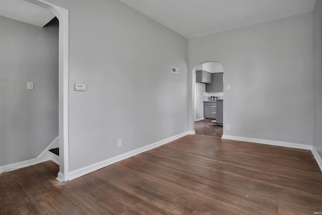 314 S Welworth Ave, Evansville, IN 47714 - spare room with arched walkways, dark wood-style flooring, visible vents, and baseboards