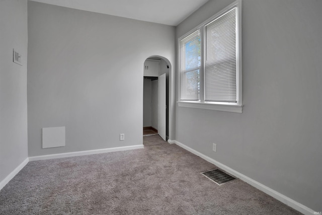 314 S Welworth Ave, Evansville, IN 47714 - empty room featuring baseboards, visible vents, arched walkways, and carpet floors