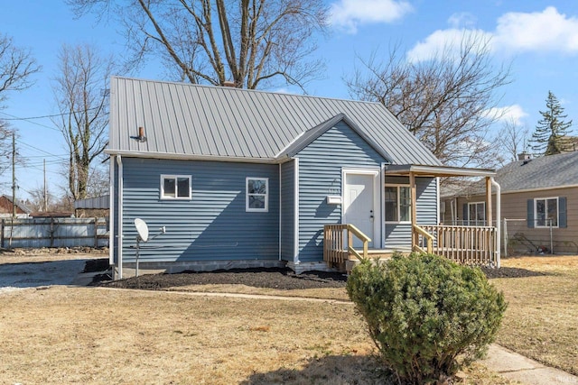 4121 Smith St, Fort Wayne, IN 46806 - view of front of home with fence, metal roof, and a front lawn