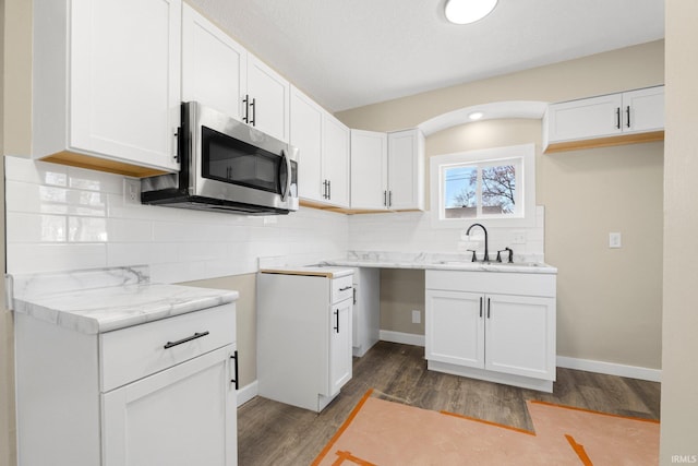 4121 Smith St, Fort Wayne, IN 46806 - kitchen featuring wood finished floors, stainless steel microwave, backsplash, and a sink